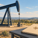 Illustration of an oil pumpjack, a folder with a Texas silhouette, papers, and stacked gold coins.