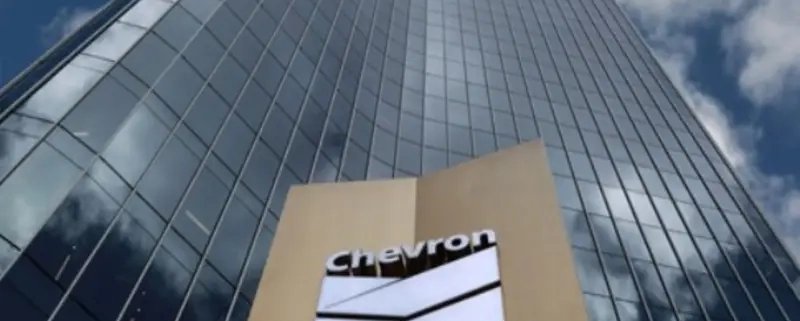 Chevron Corp. beat earnings estimates and raised dividends after posting record oil and natural gas production.